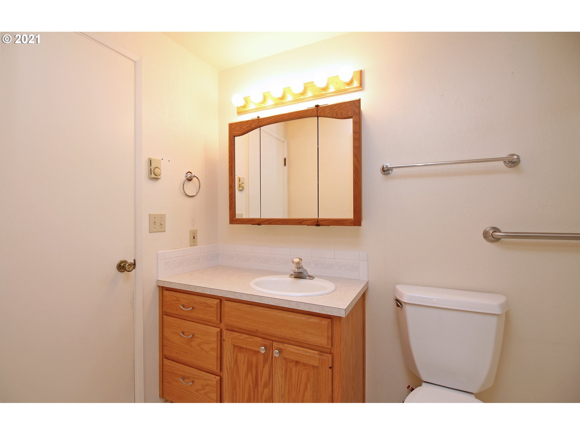 6988 B Street Springfield, OR 97478 - Photo 22 of 31 a bathroom with a sink a toilet and mirror