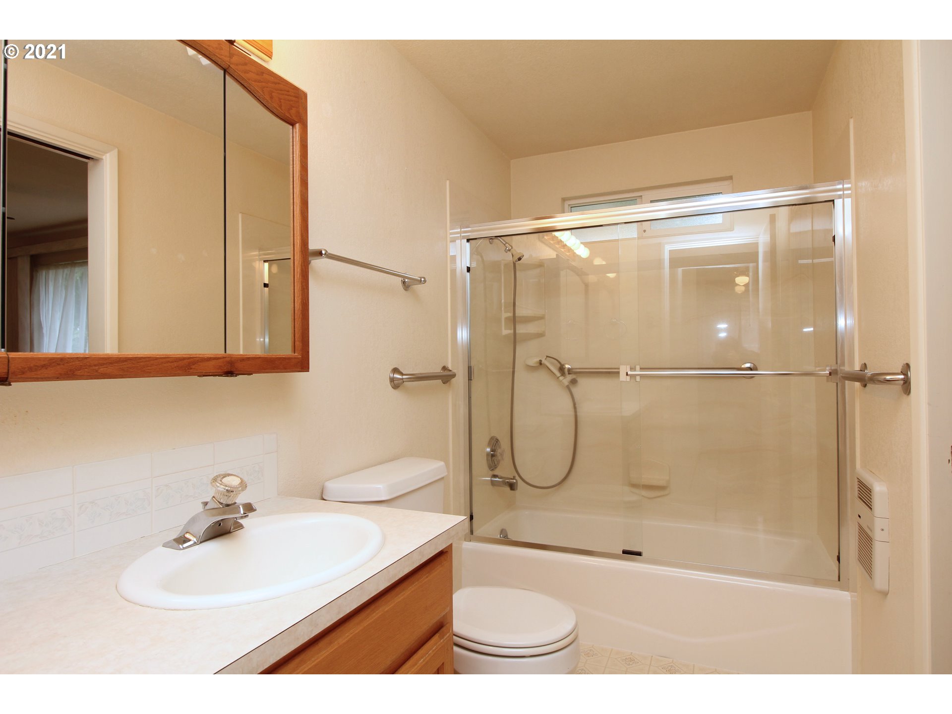 6988 B Street Springfield, OR 97478 - Photo 23 of 31 a bathroom with a shower a sink and a mirror