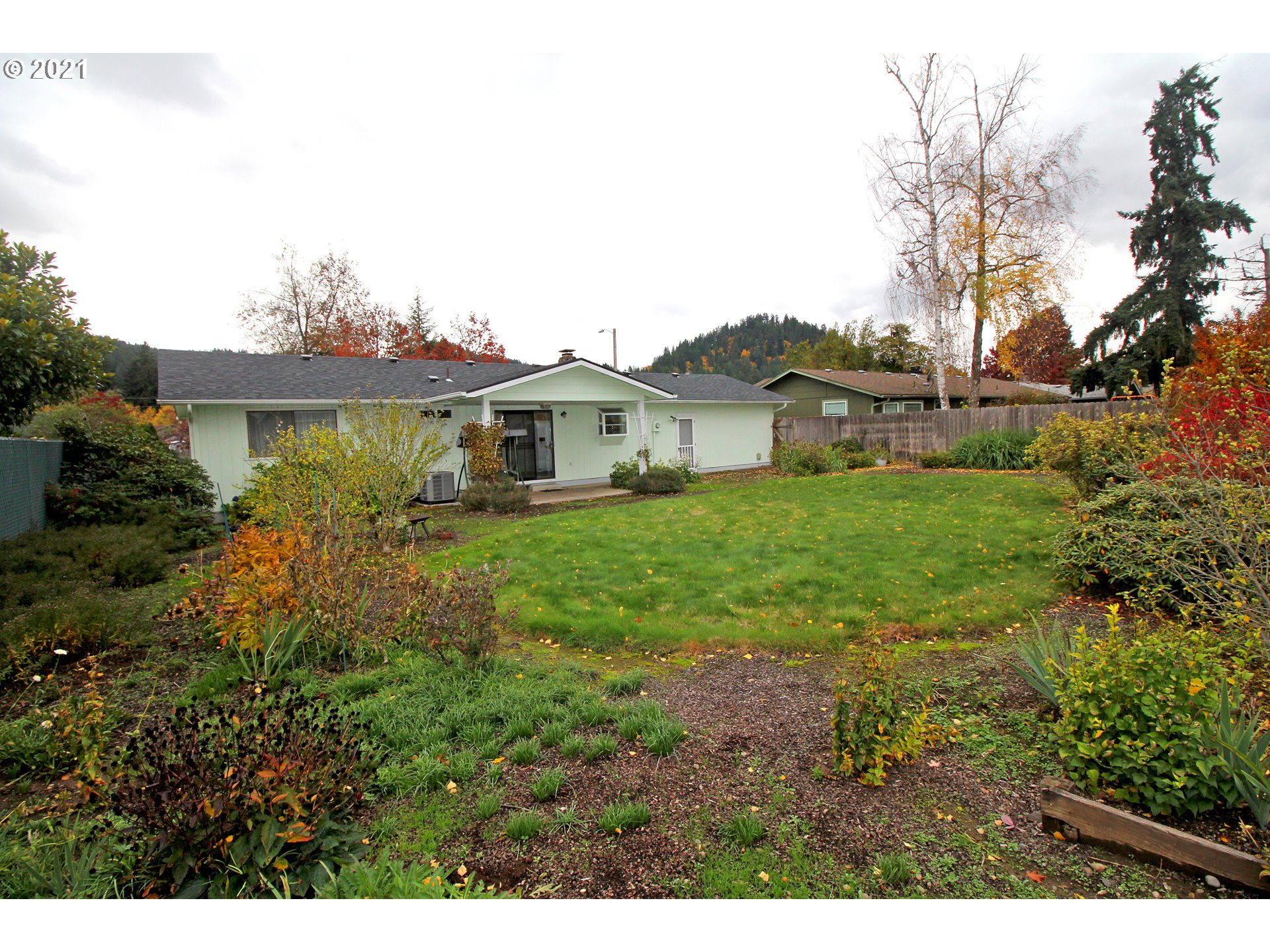 6988 B Street Springfield, OR 97478 - Photo 27 of 31 a view of a house with a big yard and large tree