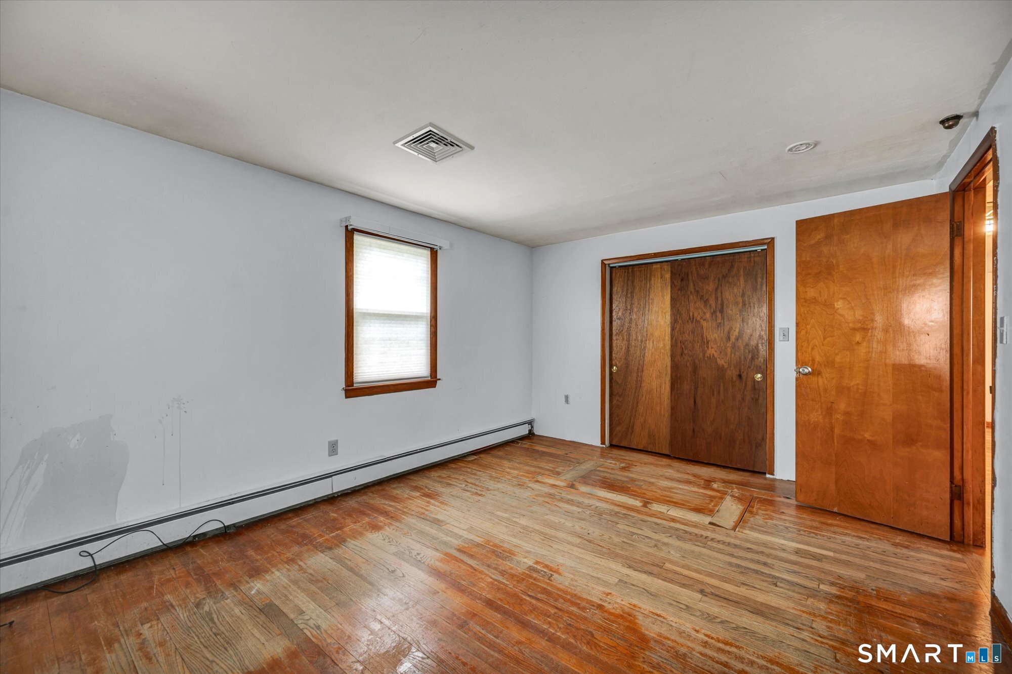 740 Rainbow Road Windsor, CT 06095 - Photo 27 of 40 an empty room with wooden floor and windows