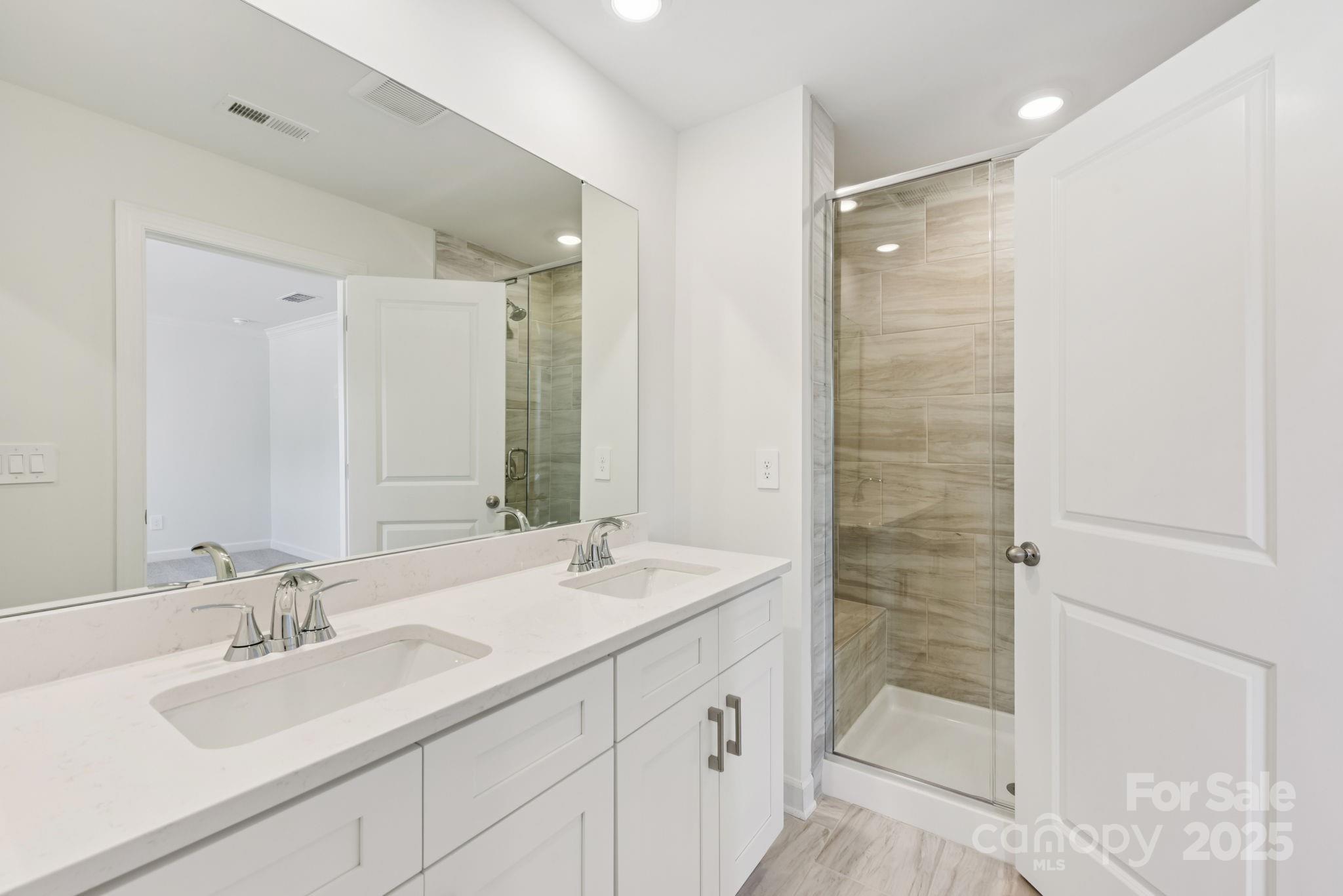 278 Tiger Lily Drive Fort Mill, SC 29708 - Photo 15 of 18 a bathroom with a double vanity sink mirror and shower