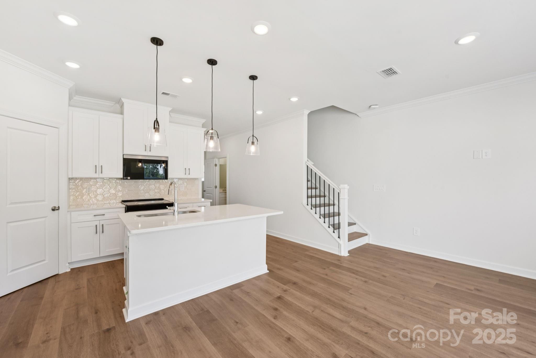 278 Tiger Lily Drive Fort Mill, SC 29708 - Photo 5 of 18 a view of kitchen with stainless steel appliances granite countertop cabinets and wooden floor