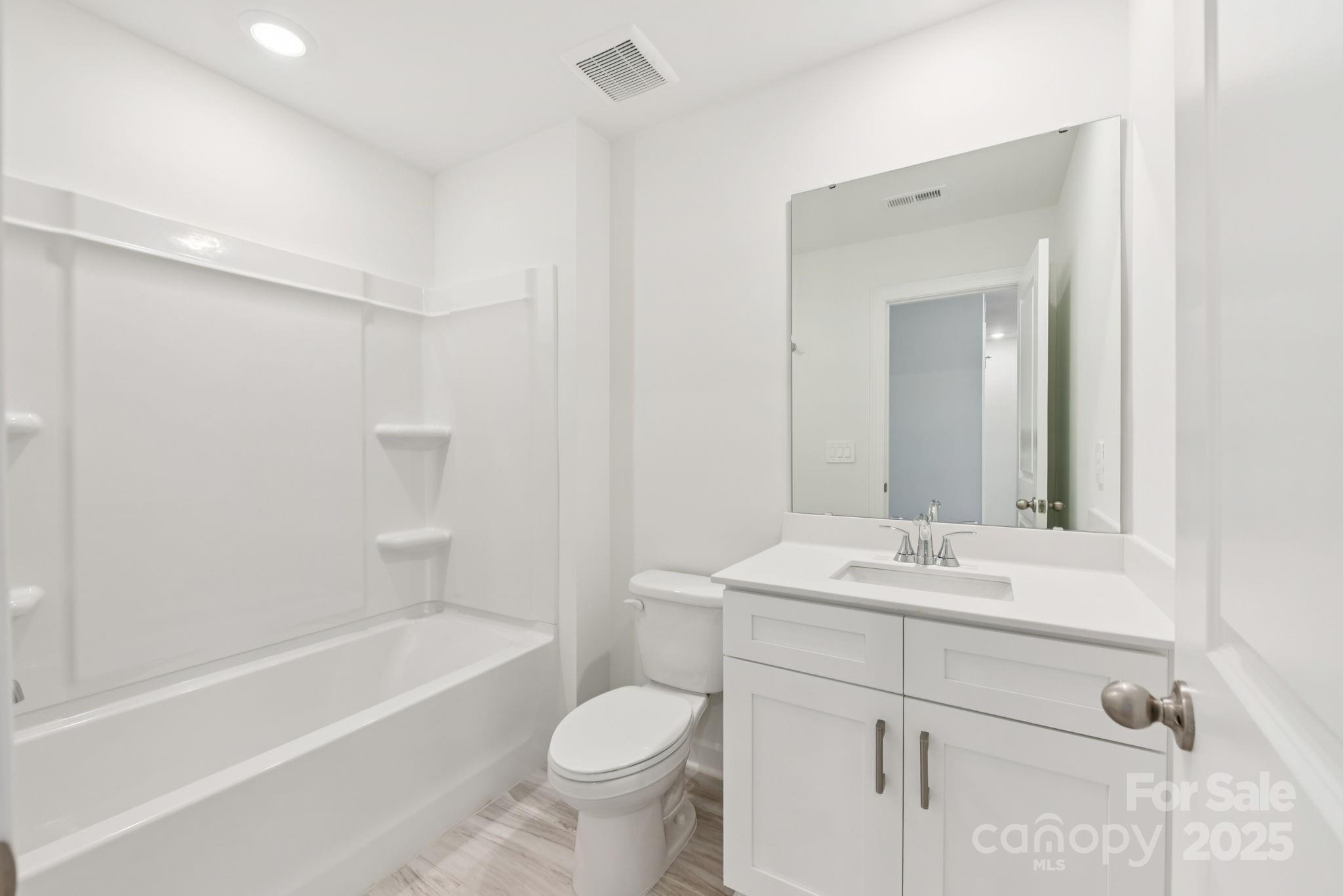 278 Tiger Lily Drive Fort Mill, SC 29708 - Photo 10 of 18 a bathroom with a sink toilet a mirror and shower