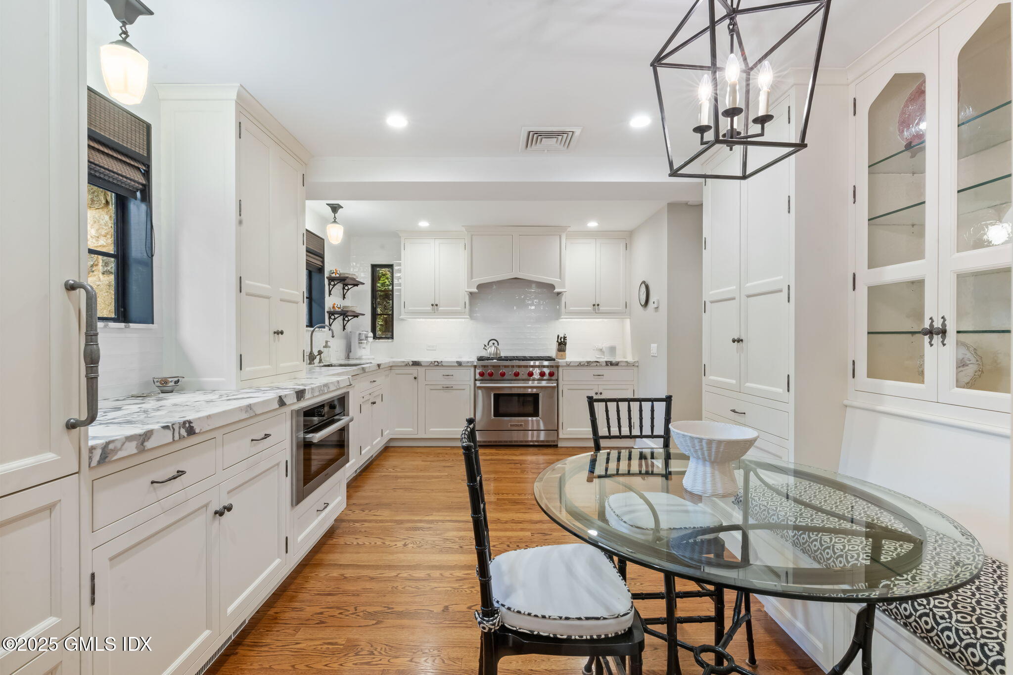 90 Brookside Drive Greenwich, CT 06831 - Photo 14 of 39 a open kitchen with stainless steel appliances granite countertop a sink a stove a dining table and chairs