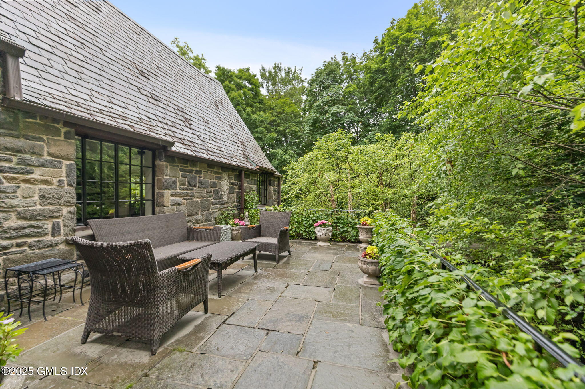 90 Brookside Drive Greenwich, CT 06831 - Photo 30 of 39 a view of a patio with table and chairs and potted plants
