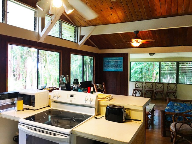 65 Kalo Road Hana, HI 96713 - Photo 6 of 30 a kitchen with a table chairs and a large window