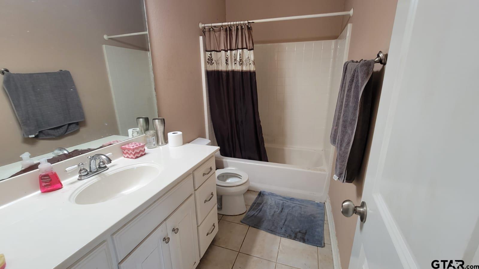 100 Thames Drive Bullard, TX 75757 - Photo 20 of 32 a bathroom with a sink vanity mirror and toilet