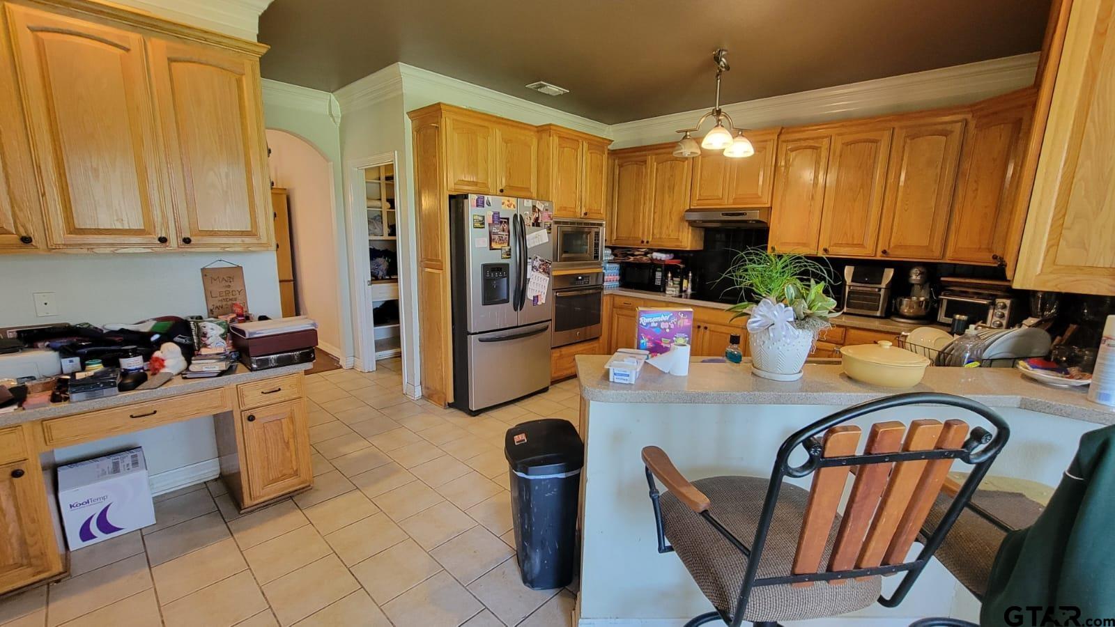 100 Thames Drive Bullard, TX 75757 - Photo 8 of 32 a kitchen with stainless steel appliances granite countertop a refrigerator and microwave