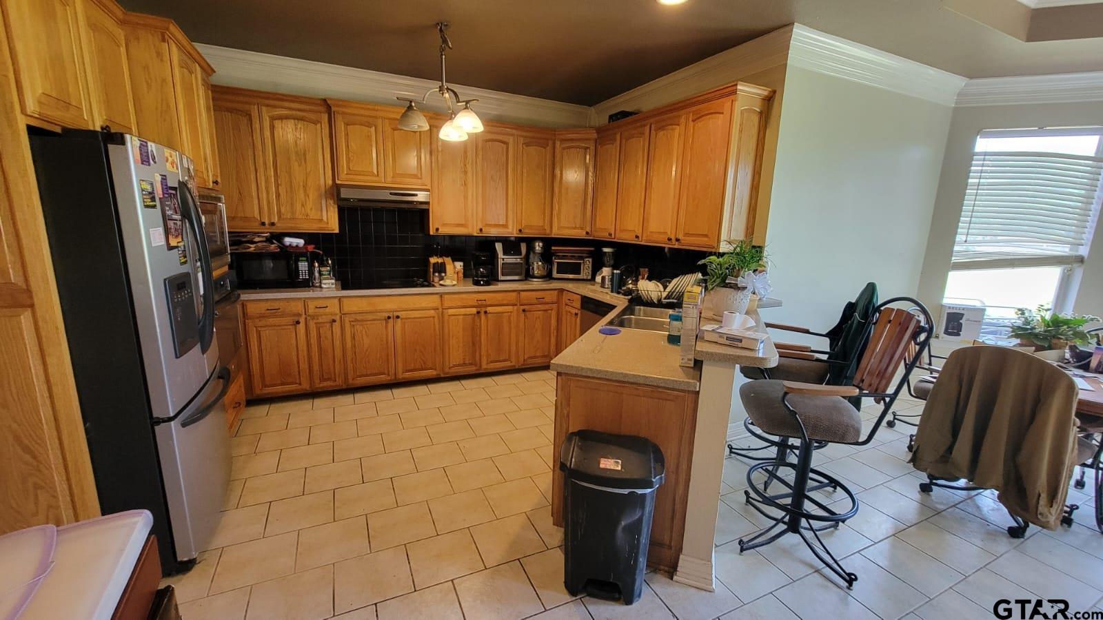 100 Thames Drive Bullard, TX 75757 - Photo 10 of 32 a kitchen with a sink a stove and a refrigerator