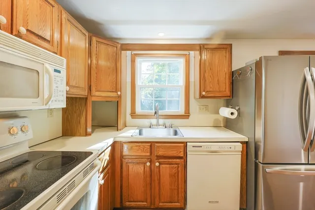 a kitchen with a refrigerator and a sink
