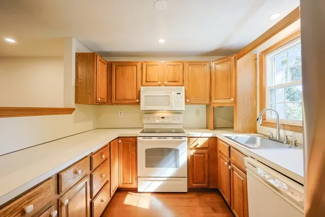 a kitchen with a stove top oven sink and cabinets