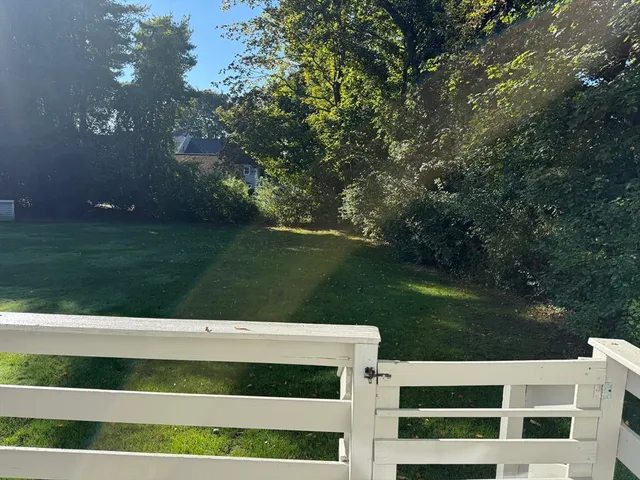 a view of a white house with a yard