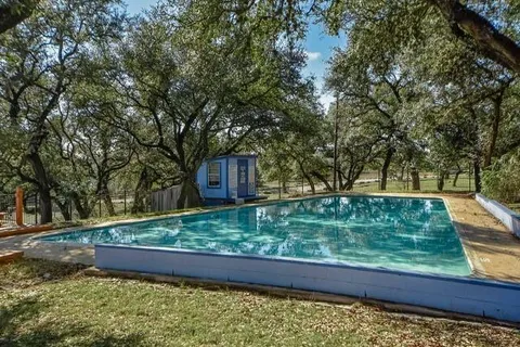 a view of a garden with wooden fence