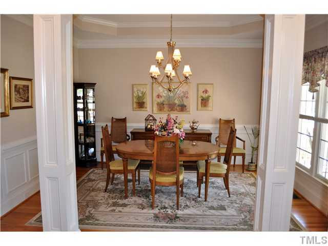 Dining room features hard wood floors, crown molding, trey ceiling with inlaid crown. Dining Room