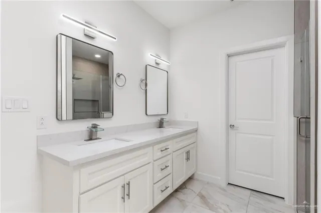a bathroom with a double vanity sink mirror and
