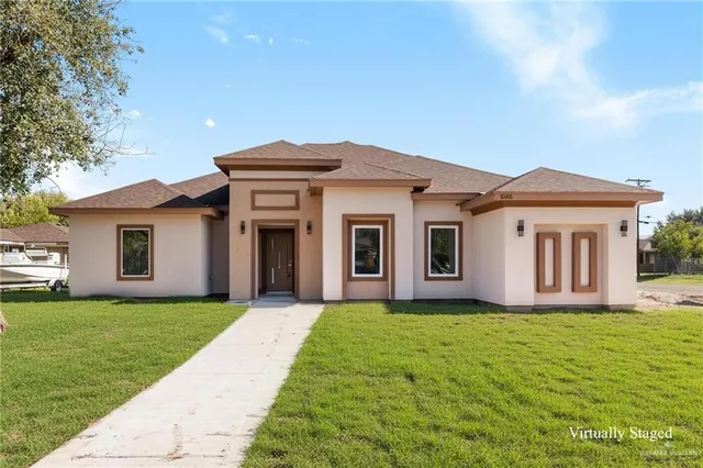 a front view of house with yard and green space