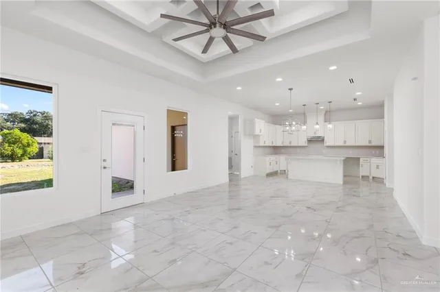 a view of a kitchen with kitchen island a sink stainless steel appliances and cabinets