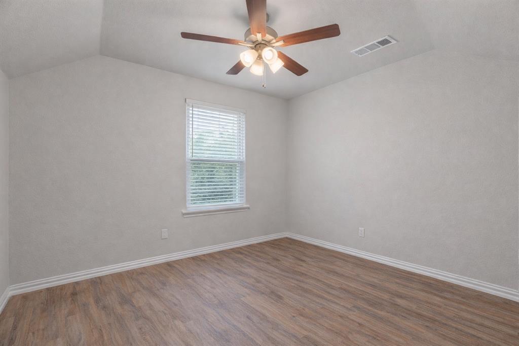 608 Porcupine Drive Springtown, TX 76082 - Photo 14 of 37 wooden floor in an empty room with a window