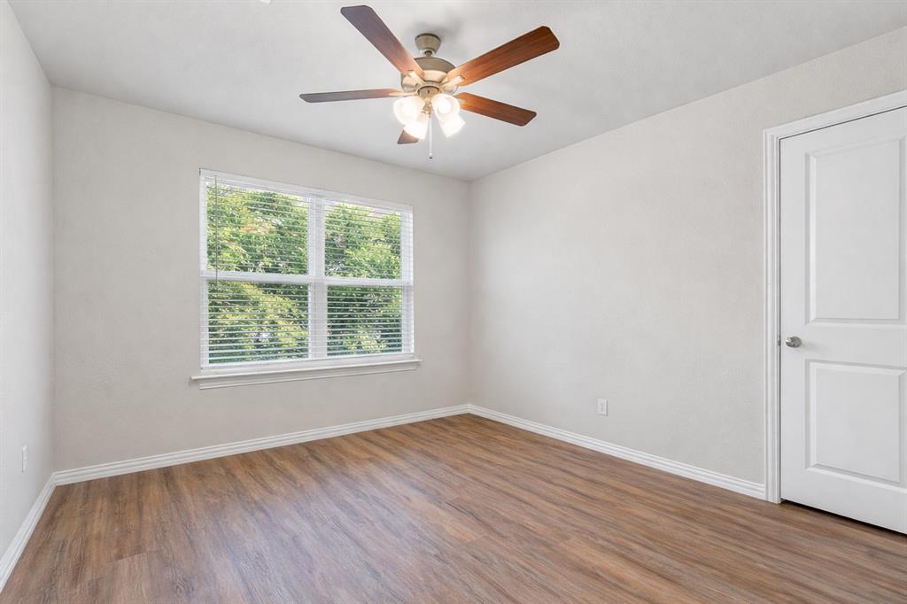 608 Porcupine Drive Springtown, TX 76082 - Photo 18 of 37 an empty room with wooden floor and windows