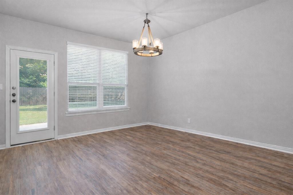 608 Porcupine Drive Springtown, TX 76082 - Photo 8 of 37 wooden floor in an empty room with a window