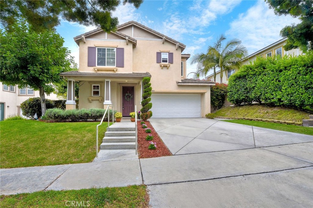 1882 Sheep Ranch Loop Chula Vista, CA 91913 - Photo 1 of 1 a front view of a house with a yard and potted plants