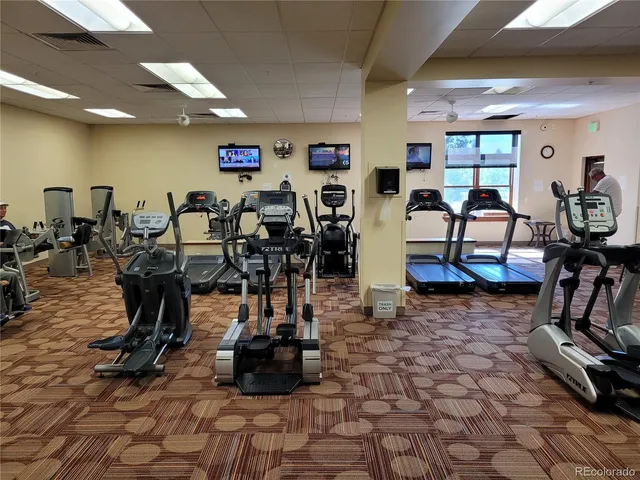 a kitchen with stainless steel appliances kitchen island granite countertop a stove a sink and a refrigerator