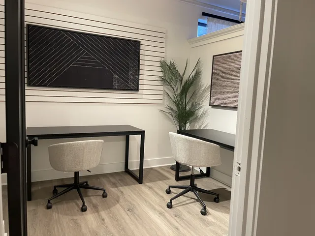 a workspace with furniture and a potted plant