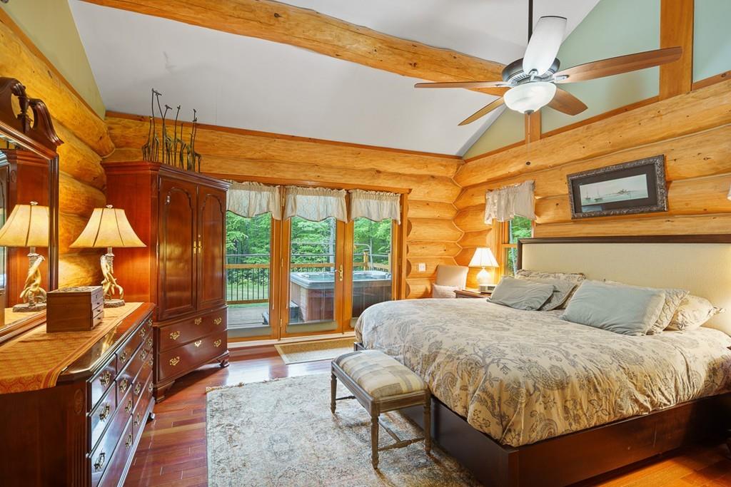 49 Beaman Road Princeton, MA 01541 - Photo 16 of 42 a bedroom with a bed and wooden floor