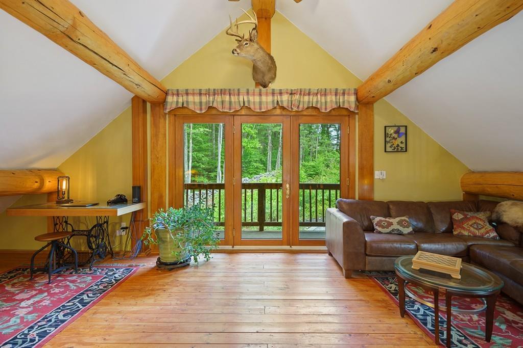 49 Beaman Road Princeton, MA 01541 - Photo 24 of 42 a living room with furniture floor to ceiling window and wooden floor