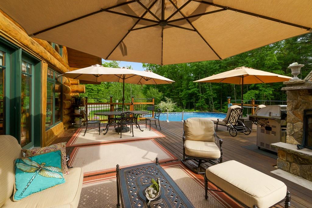 49 Beaman Road Princeton, MA 01541 - Photo 41 of 42 a view of a patio with couches table and chairs under an umbrella