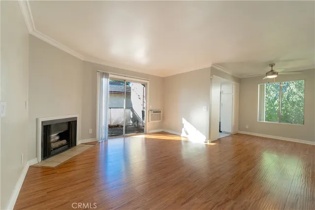 a view of an empty room with window and fire place