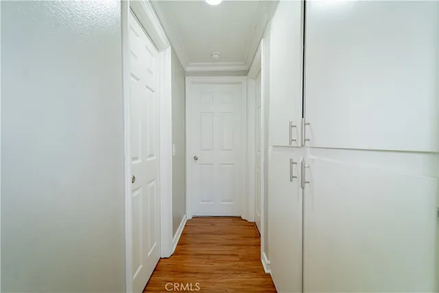 a view of a hallway with wooden floor and staircase