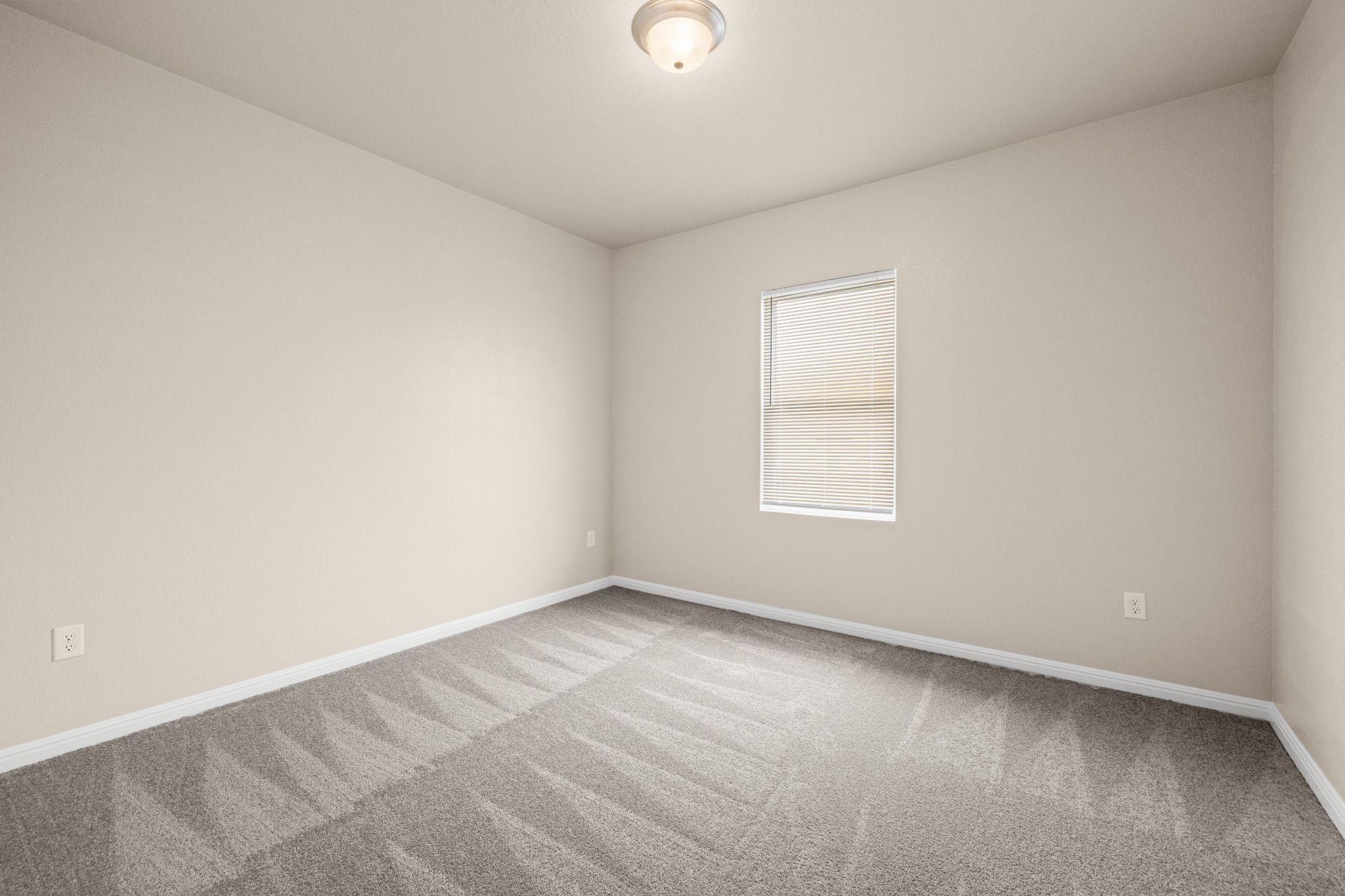 241 Night Riders Way Jarrell, TX 76537 - Photo 14 of 39 Empty room with light colored carpet and baseboards