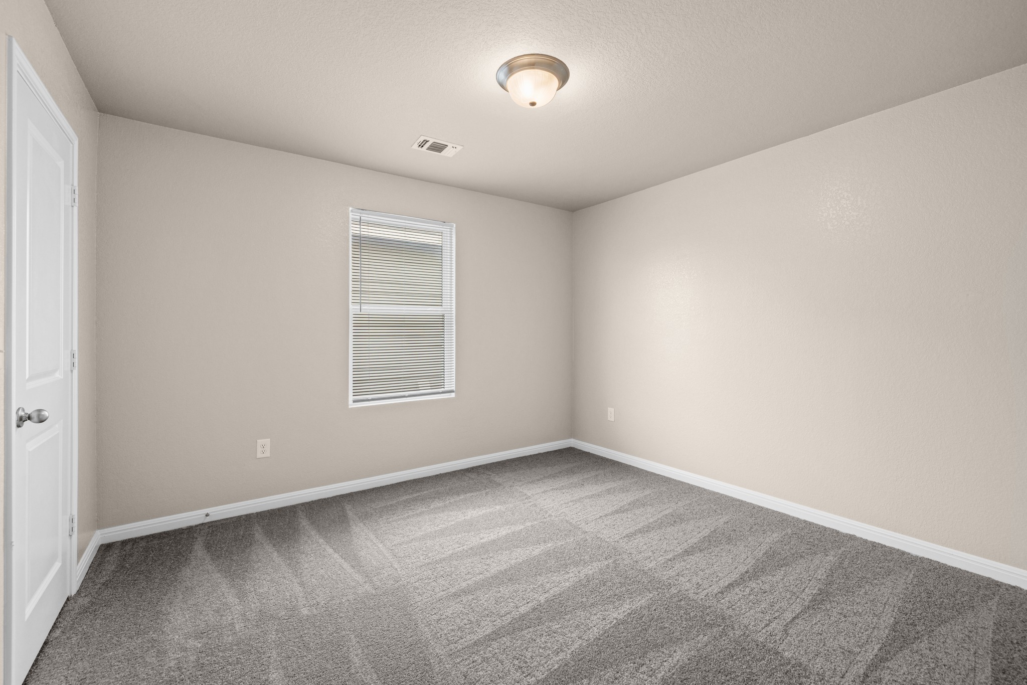 241 Night Riders Way Jarrell, TX 76537 - Photo 22 of 39 Unfurnished bedroom featuring light carpet and baseboards