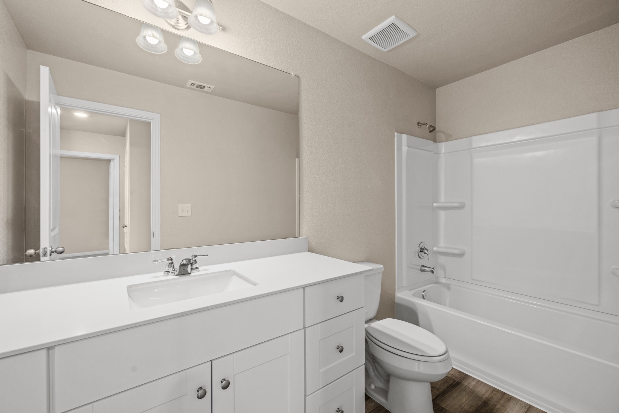 241 Night Riders Way Jarrell, TX 76537 - Photo 24 of 39 Bathroom featuring vanity, shower / washtub combination, and dark wood-style flooring