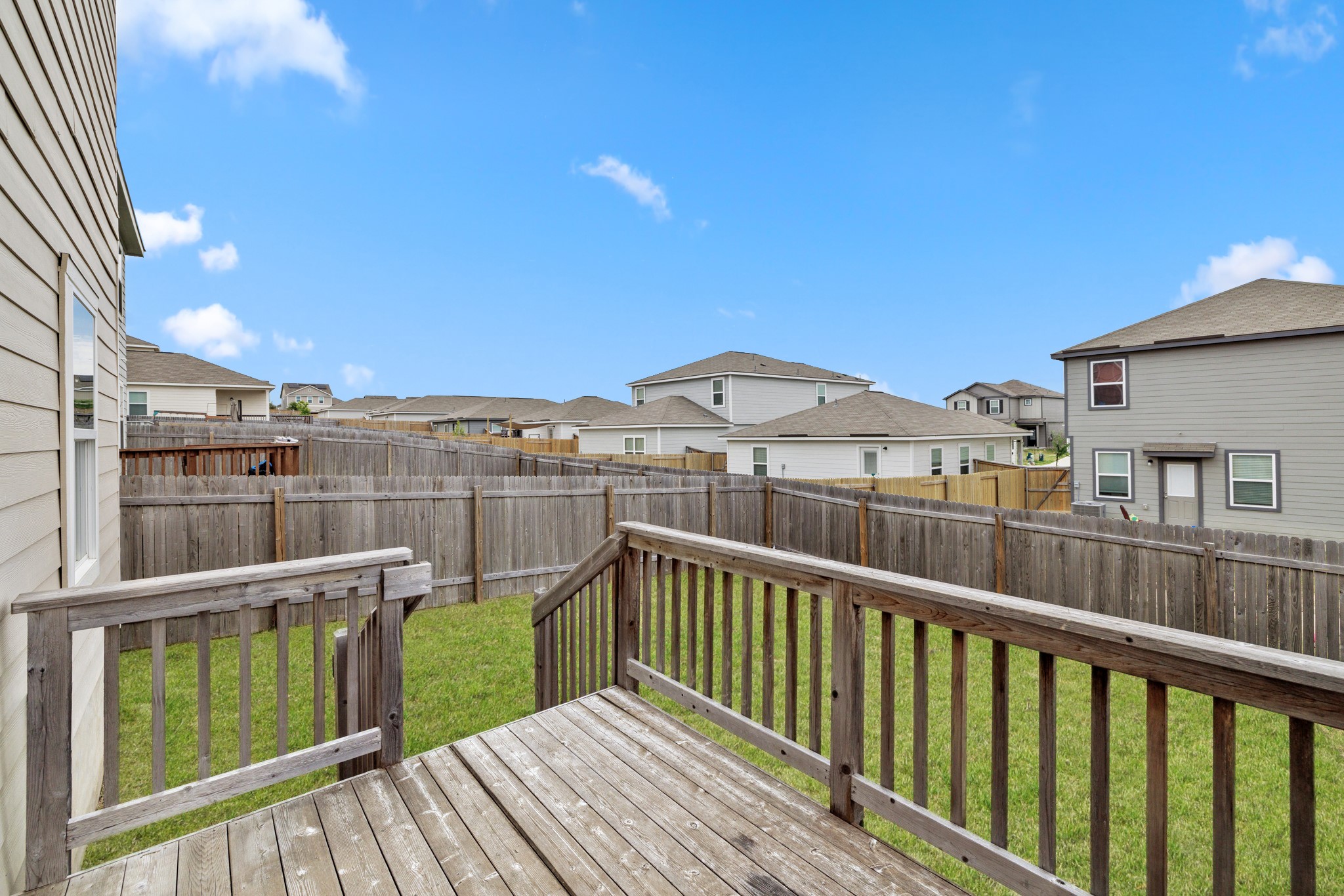 241 Night Riders Way Jarrell, TX 76537 - Photo 26 of 39 Wooden deck featuring a residential view and a fenced backyard