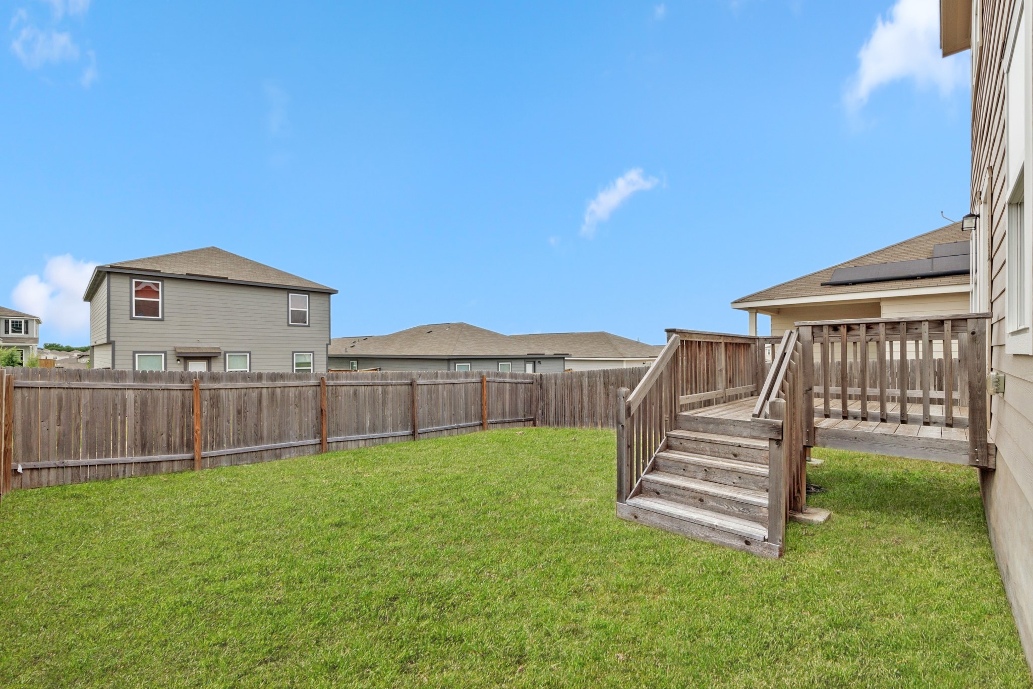 241 Night Riders Way Jarrell, TX 76537 - Photo 28 of 39 Fenced backyard featuring a deck and a residential view