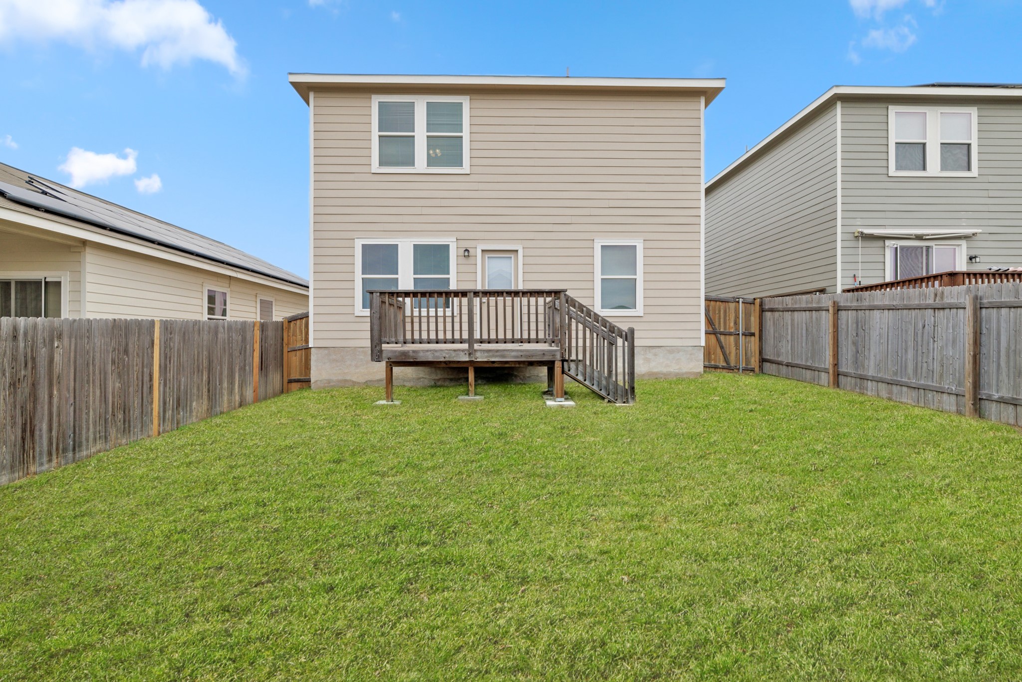 241 Night Riders Way Jarrell, TX 76537 - Photo 30 of 39 Rear view of property featuring a wooden deck and a fenced backyard