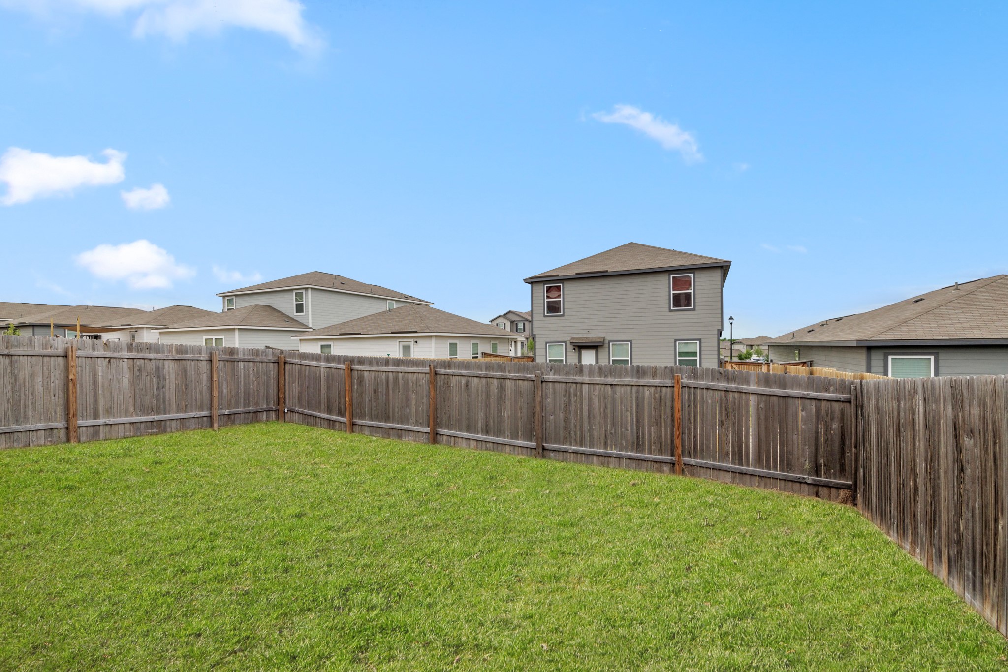 241 Night Riders Way Jarrell, TX 76537 - Photo 31 of 39 Fenced backyard with a residential view