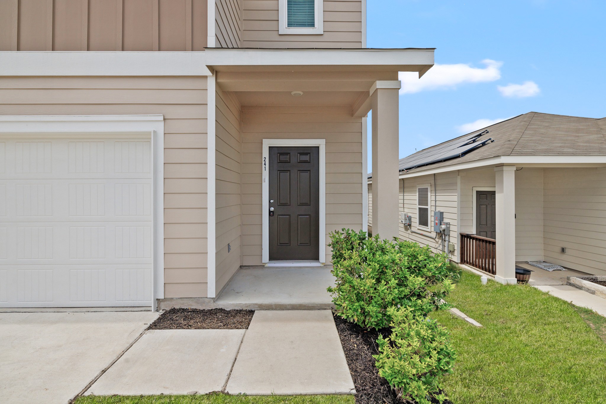 241 Night Riders Way Jarrell, TX 76537 - Photo 4 of 39 Entrance to property with a garage and a lawn