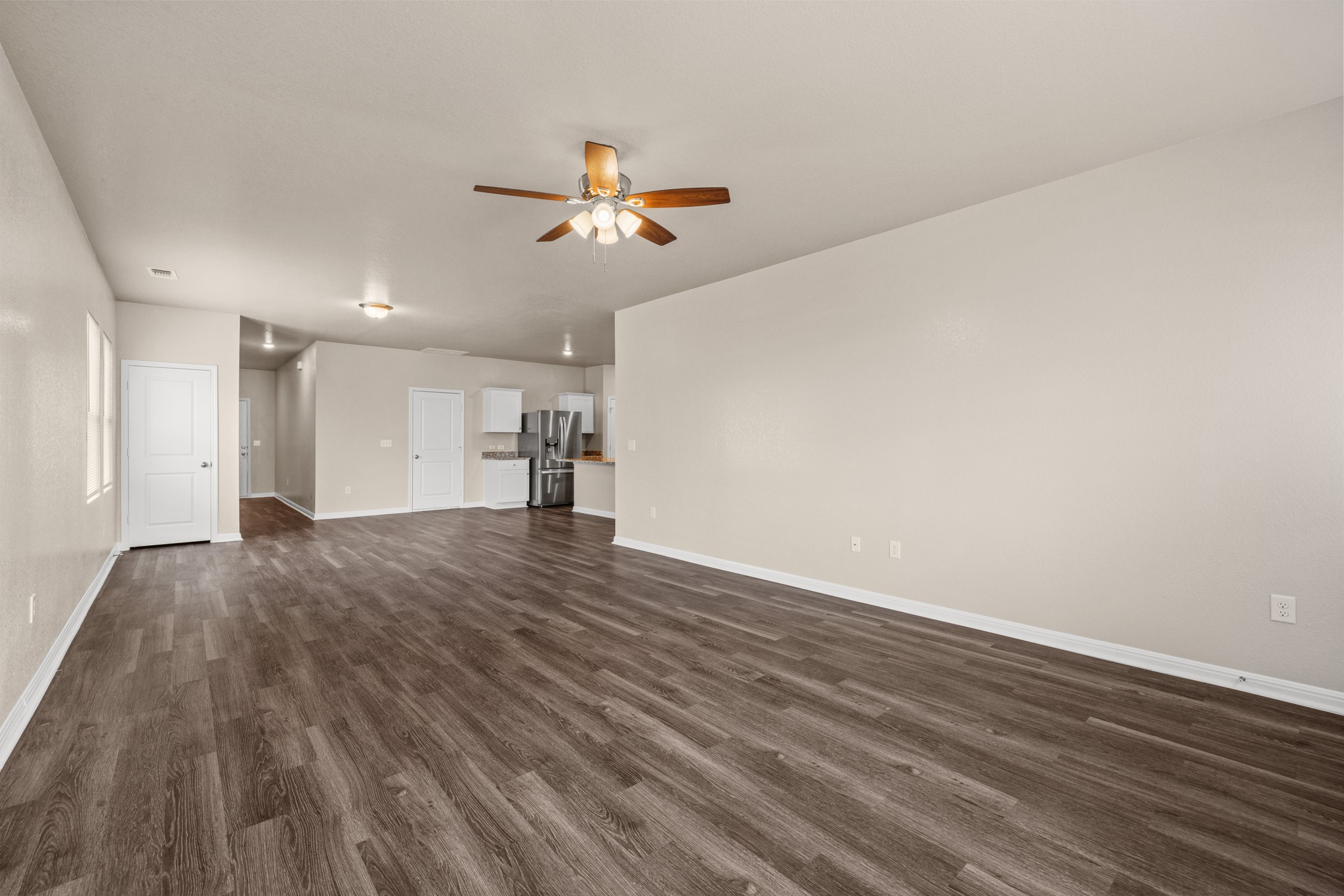 241 Night Riders Way Jarrell, TX 76537 - Photo 9 of 39 Unfurnished living room with dark wood-type flooring and ceiling fan