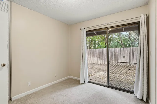 an empty room with sliding glass door