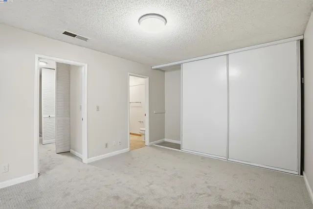a bathroom with a granite countertop sink toilet and mirror