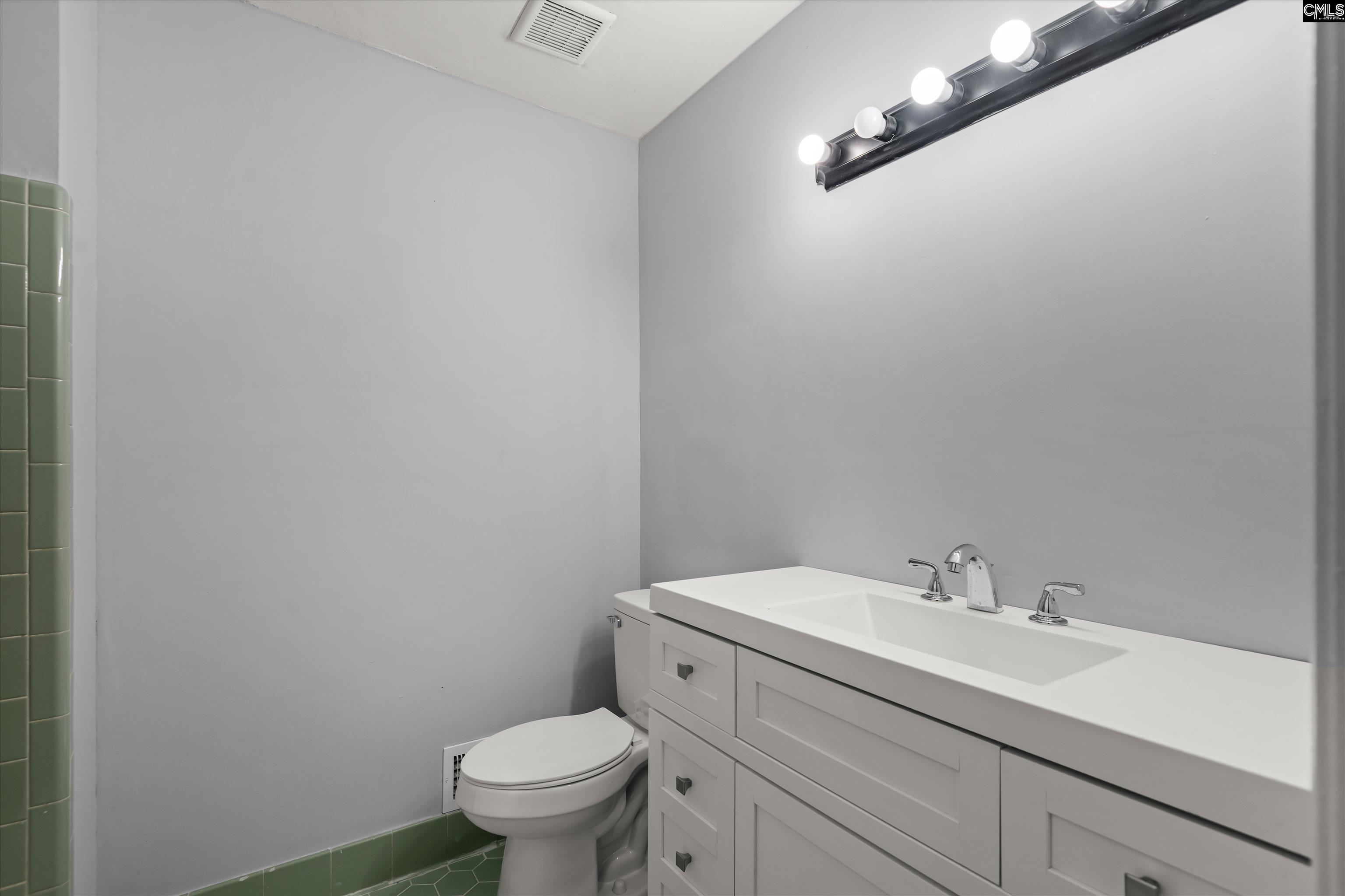 245 Piney Grove Road Columbia, SC 29210 - Photo 23 of 29 a bathroom with a sink a toilet and a mirror