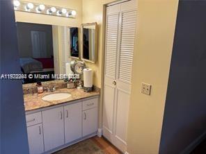 3571 Inverrary Drive, Unit 408 Lauderhill, FL 33319 - Photo 13 of 13 a bathroom with a granite countertop sink and a mirror