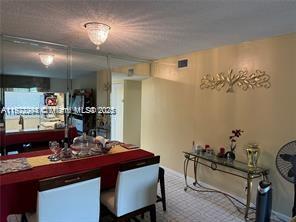 3571 Inverrary Drive, Unit 408 Lauderhill, FL 33319 - Photo 5 of 13 a room with a table chairs and entryway