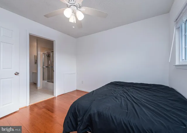 a bedroom with a bed and a chandelier fan