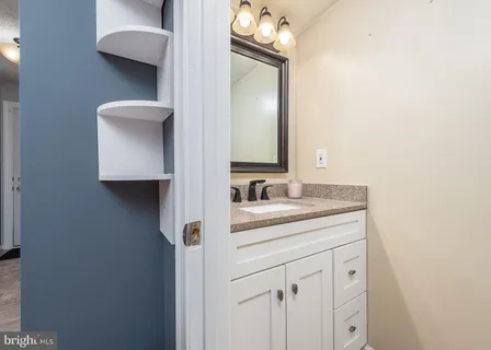 a bathroom with a sink vanity and mirror