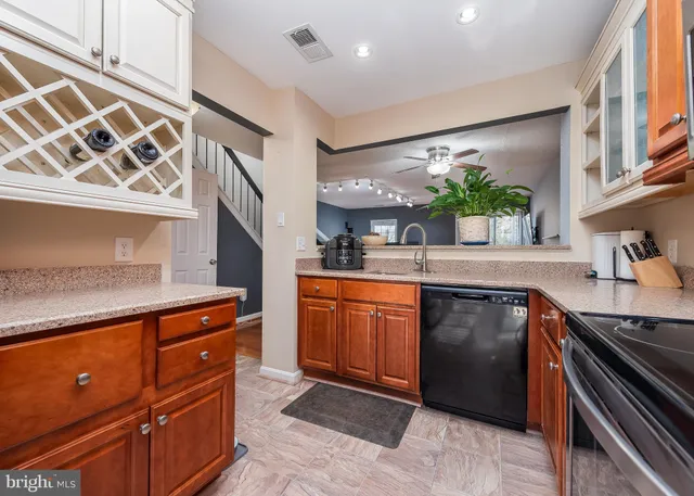 a kitchen with stainless steel appliances granite countertop a sink stove and cabinets
