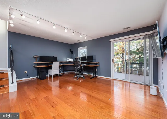 a view of a livingroom with workspace and a window